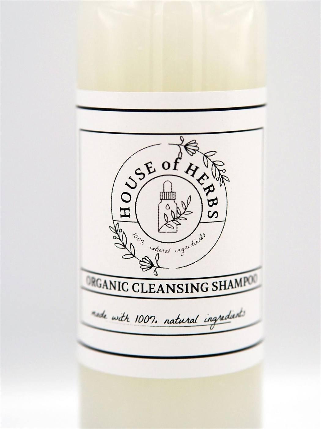 Closer studio photo of the House of Herbs Hair Cleansing Shampoo bottle.