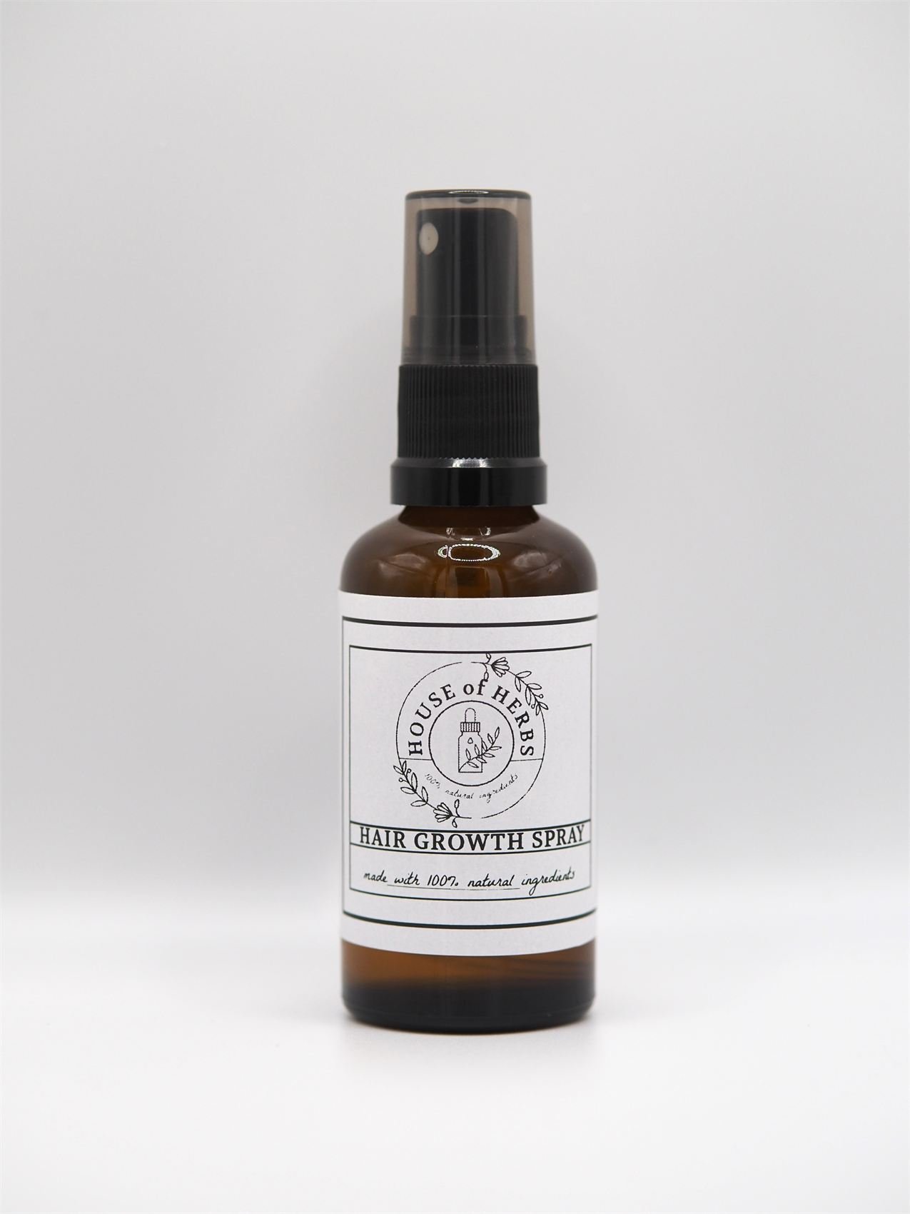 House of Herbs Hair Growth Spray bottle on a white studio background.
